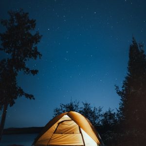 A serene campsite under a starry sky in Ely, Minnesota. Perfect outdoor adventure setting.